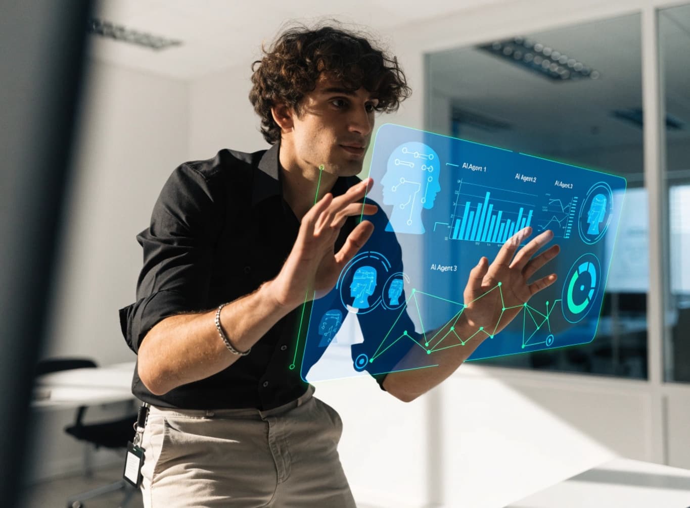 Man in black shirt interacting with a holographic interface showing data visuals.